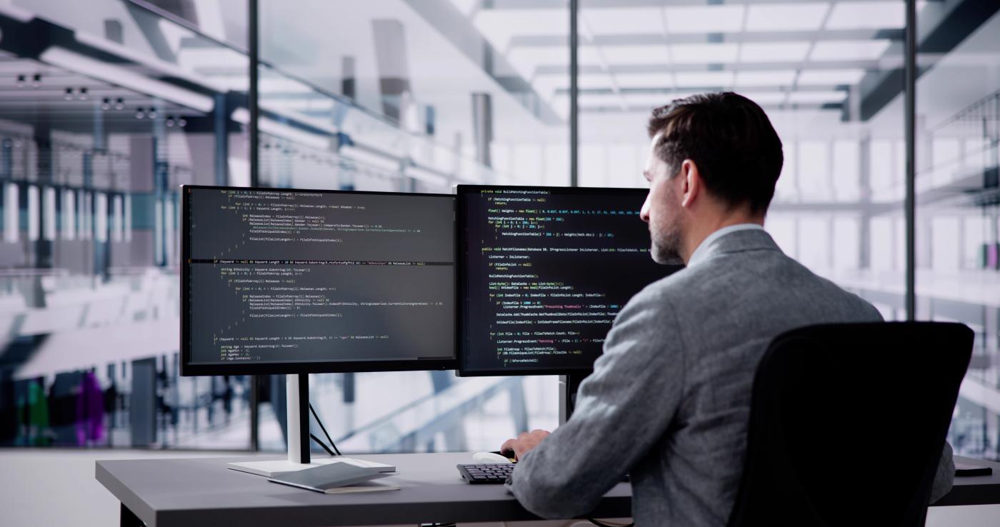An image of a man working at a computer.